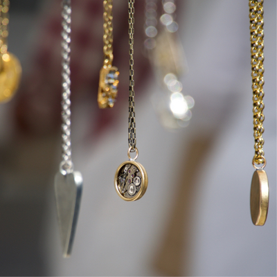 Close up shot of multiple necklace pendants.